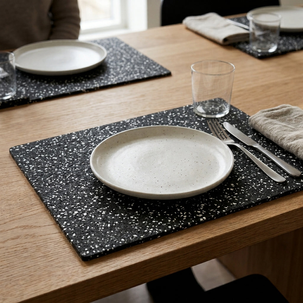rubber placemats from recycled rubber. Placed on table with tableware and cutlery. 
